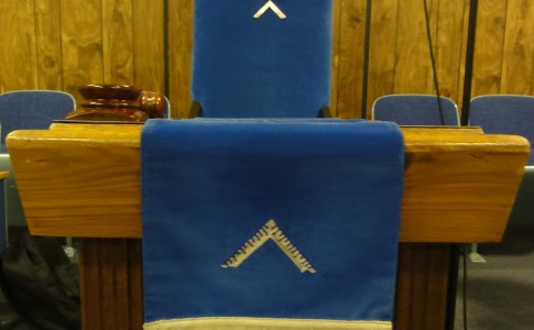 The Worshipful Master's Station in the East with Jewel, Apron, and Gavel.
