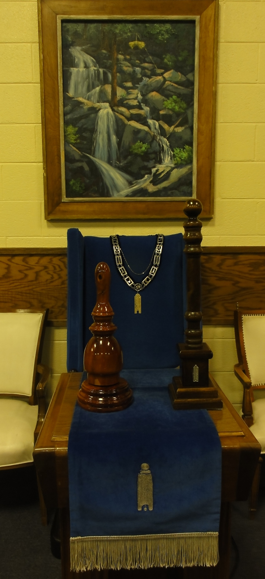 The Junior Warden's Station in the South, with jewel, apron, gavel, and pillar.