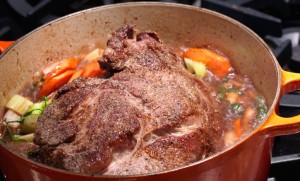 Image of a pot roast cooking on the stove.