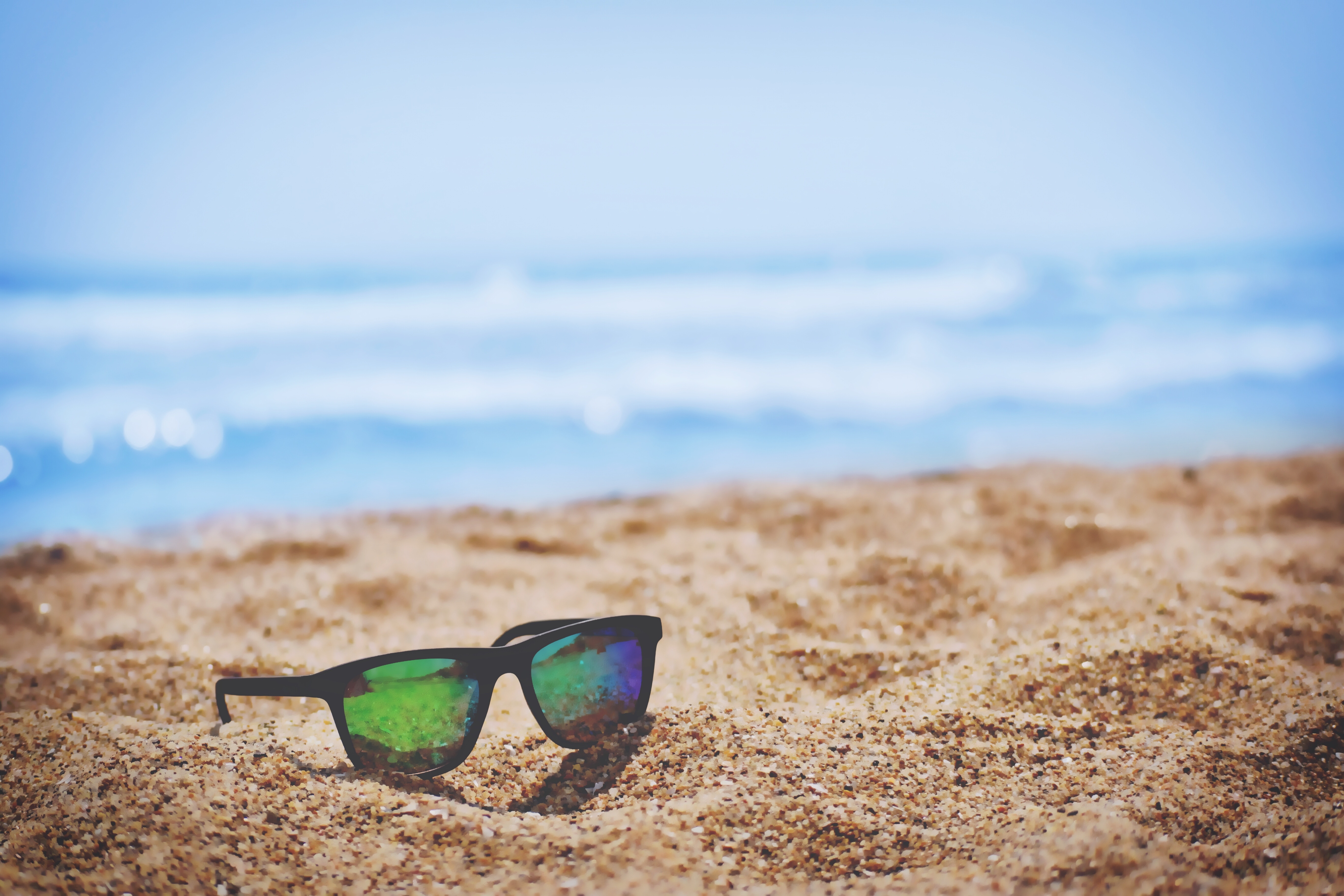 Picture of sunglasses on a beach.